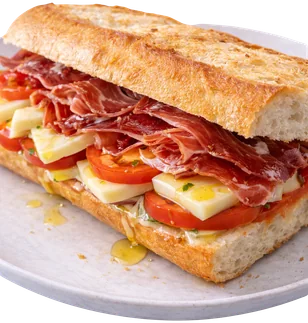 Baguette de jamón serrano con queso, tomate y aceite de oliva virgen extra